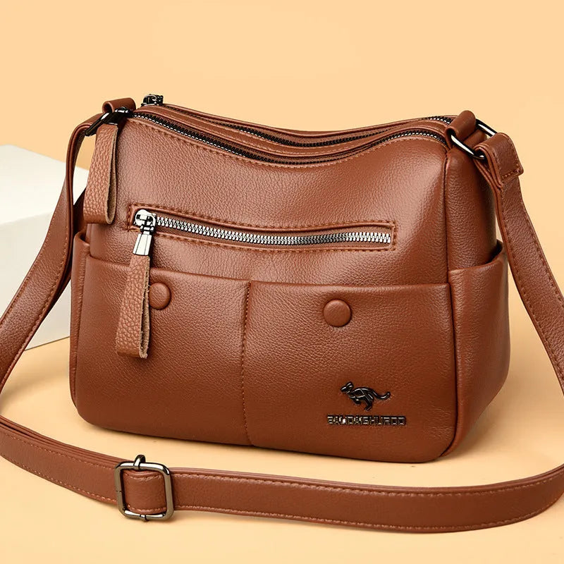 Soft PU leather crossbody shoulder bag in horizontal square shape with stitching details and multiple compartments