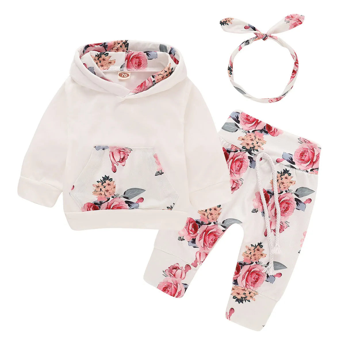 White cotton hooded pantsuit for a baby girl on a hanger, showing long sleeves and full-length trousers.