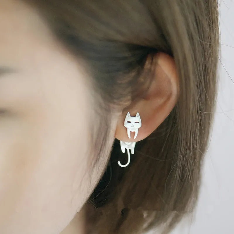 S925 sterling silver stud earrings with asymmetrical cat and fish design on white background