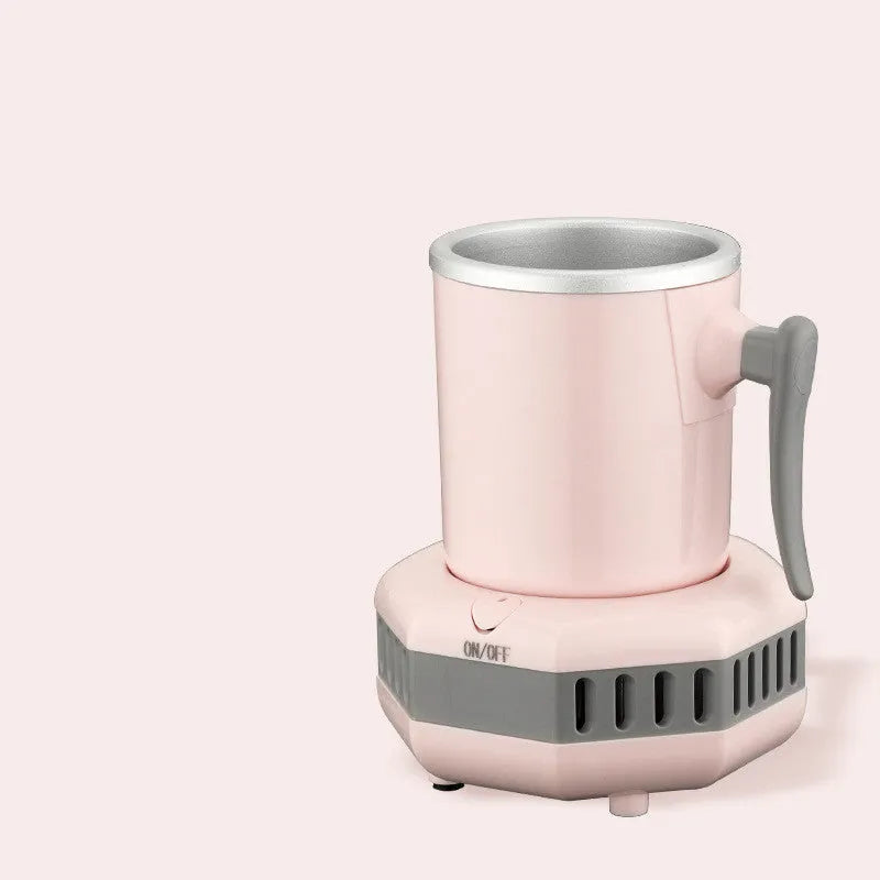 White mini quick cooling cup with aluminium drinking vessel and electronic base on a desk.