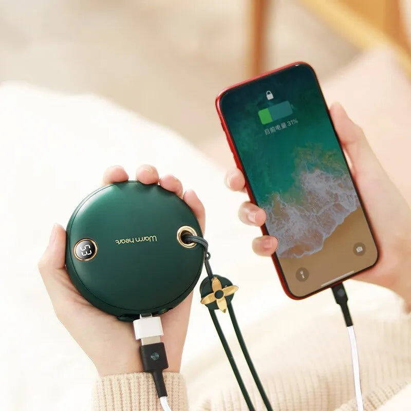 Green portable hand warmer power bank with digital display showing 5000mAh capacity