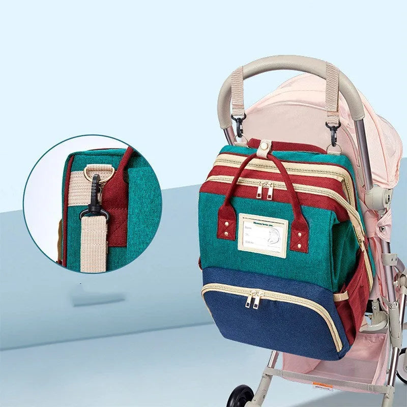 Portable folding bed mommy bag in waterproof, wear-resistant nylon with capacity expansion, available in Black, Green, Purple, Royal Blue.