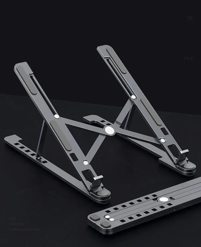 Aluminium foldable laptop stand in silver colour, shown elevated with a laptop on top