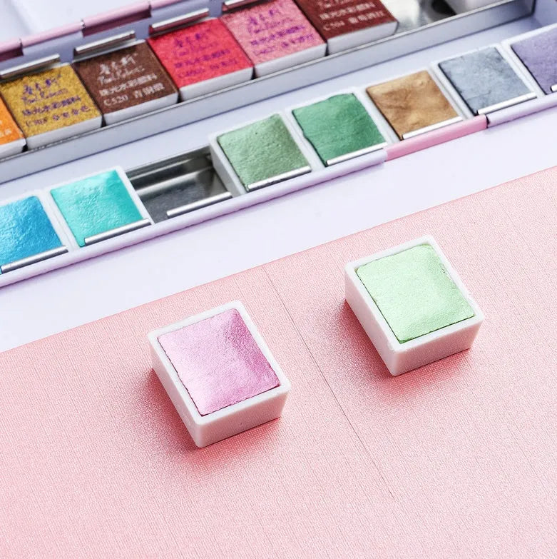 Set of solid watercolour paint pans with pearl and pearly colours, showing 12 or 24 colour options.
