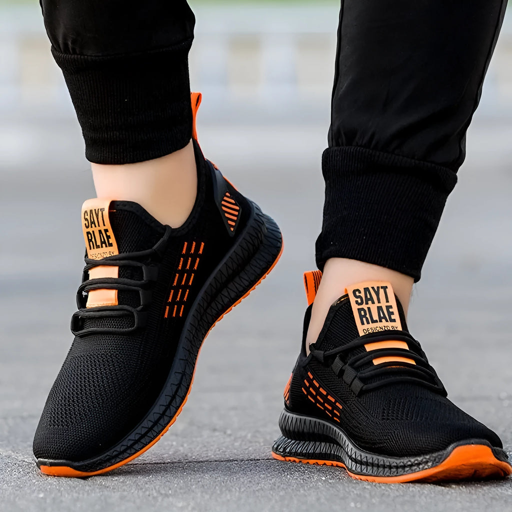 Men's black casual sports shoes with flying three-bar design and cross straps showing round toe and low-top silhouette
