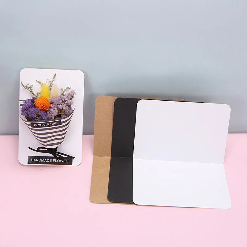 A pack of 100 blank folded kraft paper cards in 10x15cm size, shown in black, brown, and white colours.