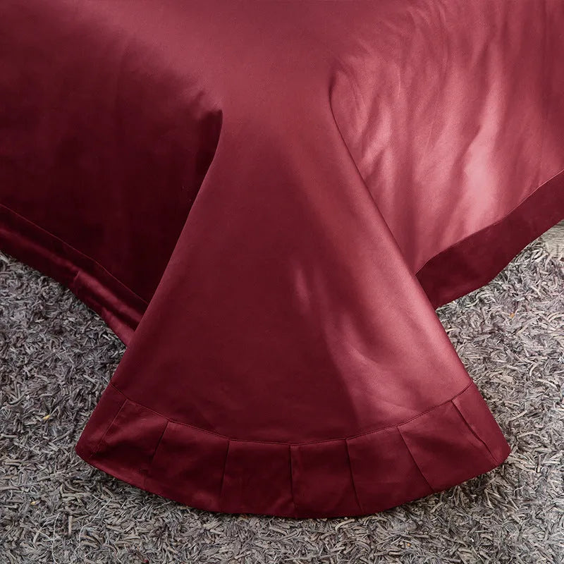 Four-piece cotton embroidery bed set in grey, comprising duvet cover, fitted sheet, and two pillowcases, satin weave finish