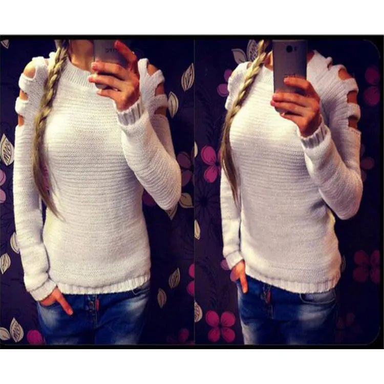 White women's hollow-out knitted long sleeve shirt with round neck on a hanger.