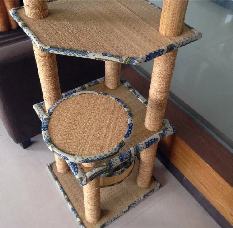 Cat playing on a natural wheat straw scratch board climbing frame with multiple levels