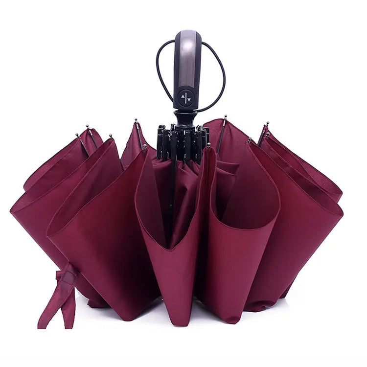 Large black automatic triple-fold umbrella with palace style canopy and rubber handle.