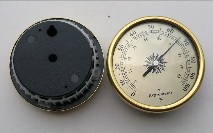 Analogue thermometer and hygrometer with aluminium ring and dial showing temperature and humidity scales.