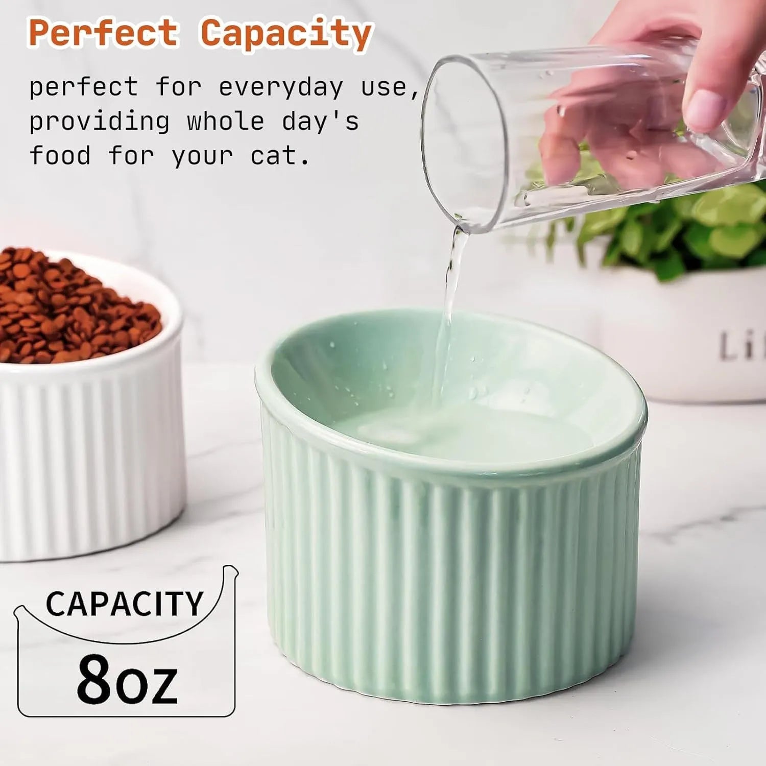 Dark green ceramic elevated cat bowl with tilted, round design on a wooden floor.