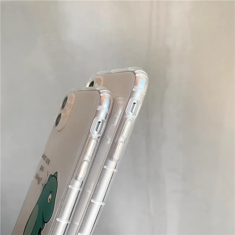 Clear transparent iPhone case with green dinosaur design showing phone protection