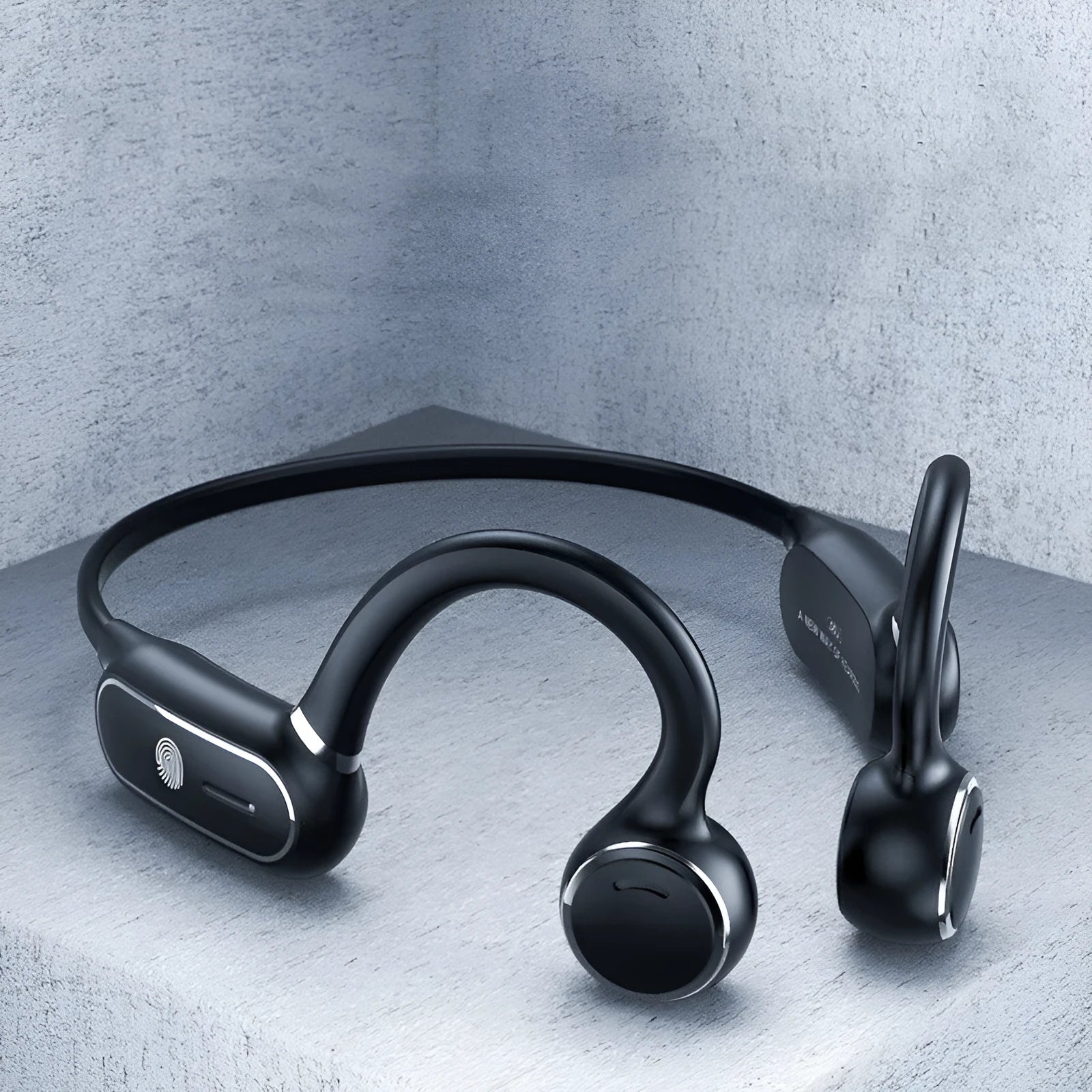 Black air conduction Bluetooth earphone with titanium wire frame shown bent for hanging