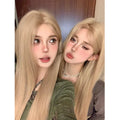 Long straight milk tea blonde synthetic wig on a stand with hair net