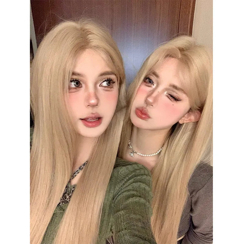 Long straight milk tea blonde synthetic wig on a stand with hair net
