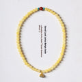 Handmade yellow jade bracelet with double ring design and lotus seedpod shapes
