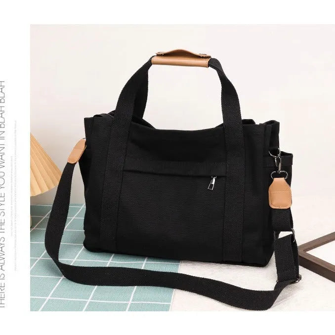 Canvas tote bag with multiple internal pockets including computer pocket, shown in horizontal square shape