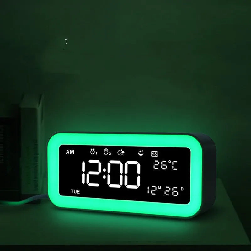 Blue rectangular LED alarm clock with digital display on a table.