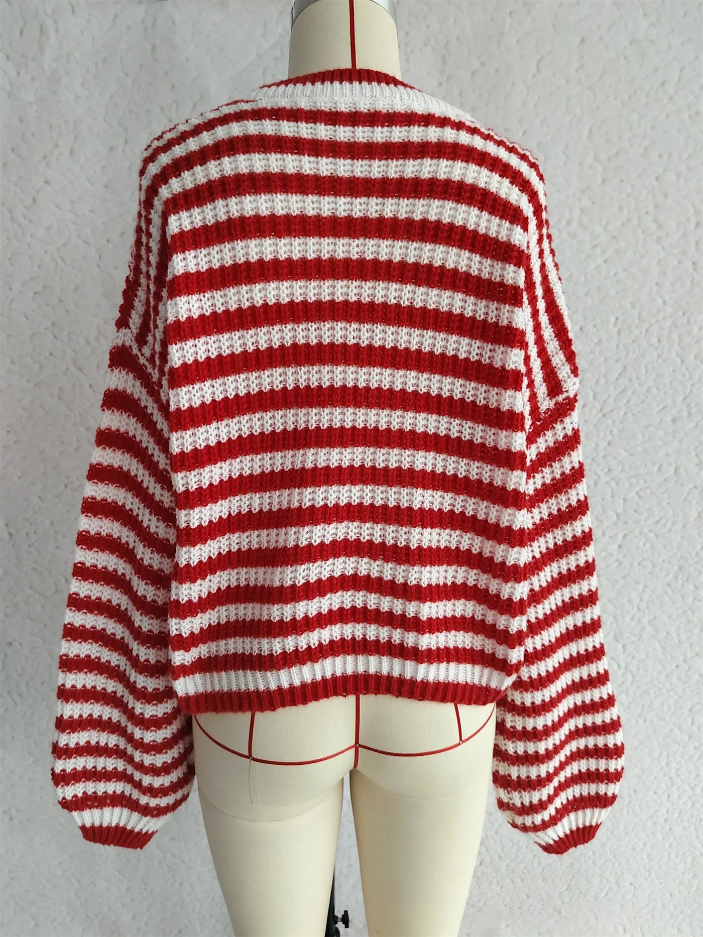 Vintage stripe women's loose fit pullover sweater in red, shown with long sleeves and a round neck.