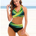 Woman wearing a striped tie-dye hollow bikini with high-waisted briefs and a backless top.