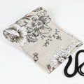 Black Peony printed canvas pencil roll bag open to show 24 or 72 holes for pencils on cotton hemp fabric.