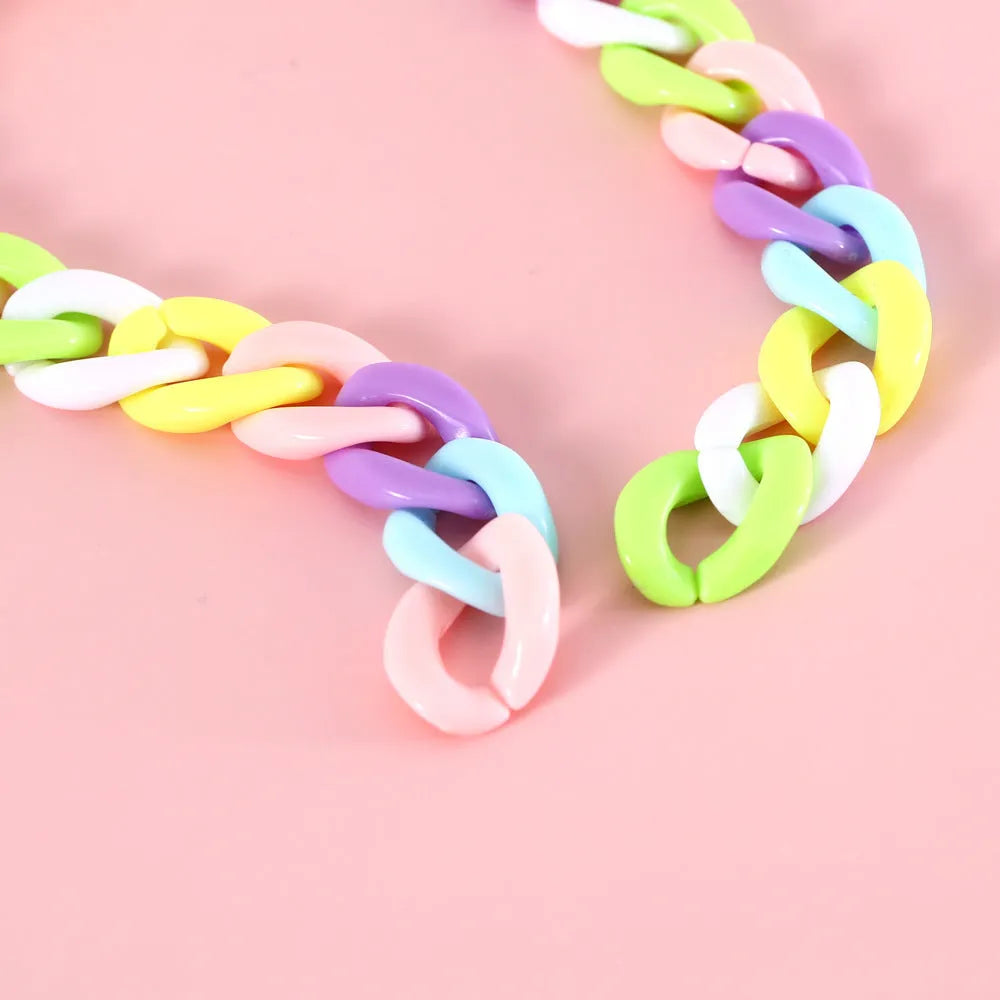 A macaron candy coloured plastic pet collar with chain detailing, shown in blue, pink, and mixed colour options.