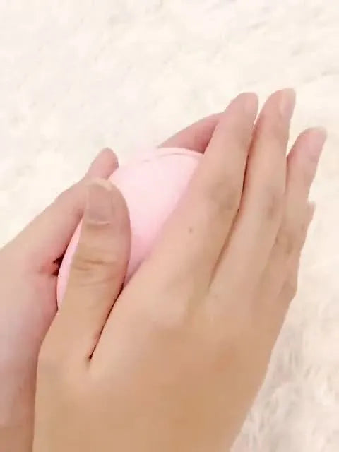 USB hand warmer in pink with three-gear temperature control and compact pebble design