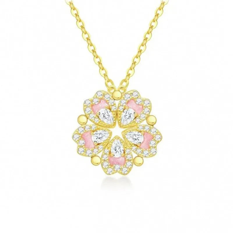 Dual-wear summer mori necklace with copper heart pendant and flower elements in gold colour on woman