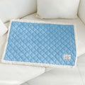 Blue quilted terry cloth pet blanket for cats showing textured surface and size scale.