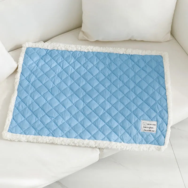 Blue quilted terry cloth pet blanket for cats showing textured surface and size scale.