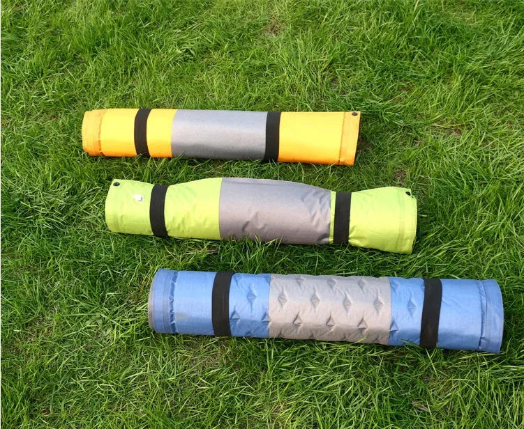 Outdoor automatic inflatable camping mat for one person with memory foam filling, blue and grey colour, shown on grass