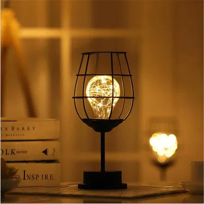 Minimalist hollow wrought iron table lamp with warm white LED light in decorative bottle style