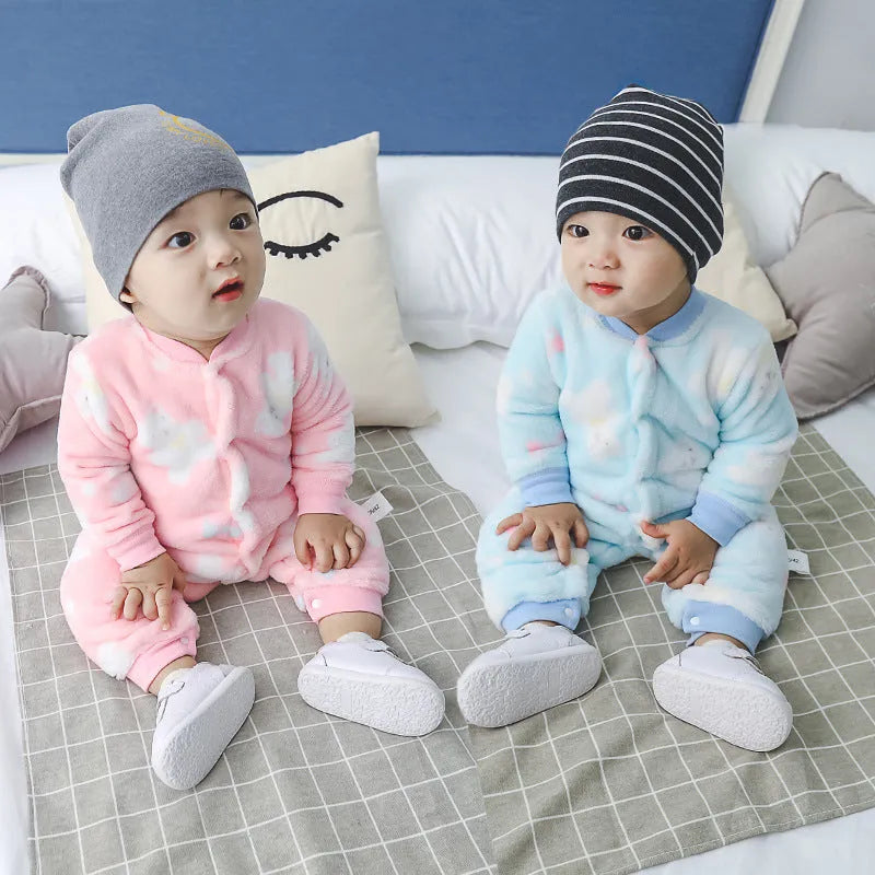 Baby wearing a long-sleeved flannel romper in a pink bunny head print, showcasing the 100% cotton fabric.
