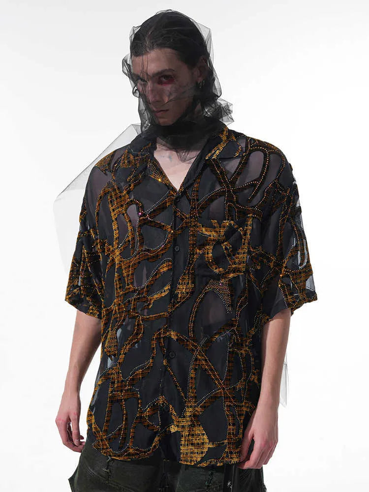 Man wearing a black and grey snake pattern short-sleeved translucent polyester shirt with a loose fit.