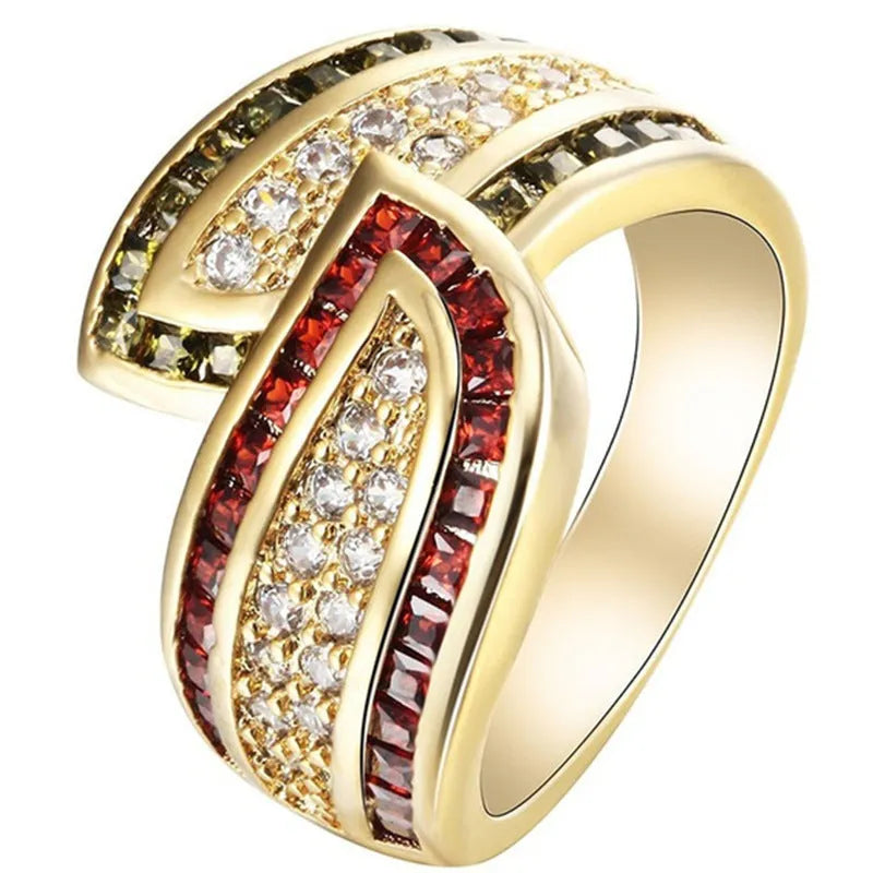 Gold women's ring with green peridot stone on finger, showing metallic finish and stone detail