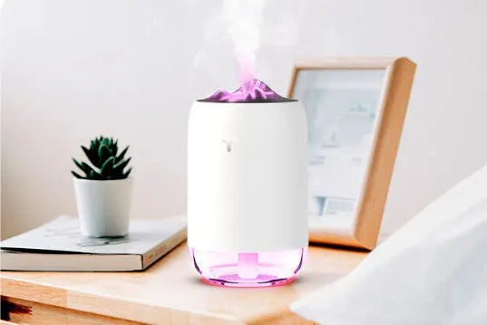 Mini cylindrical USB humidifier in turquoise green with night light on wooden desk