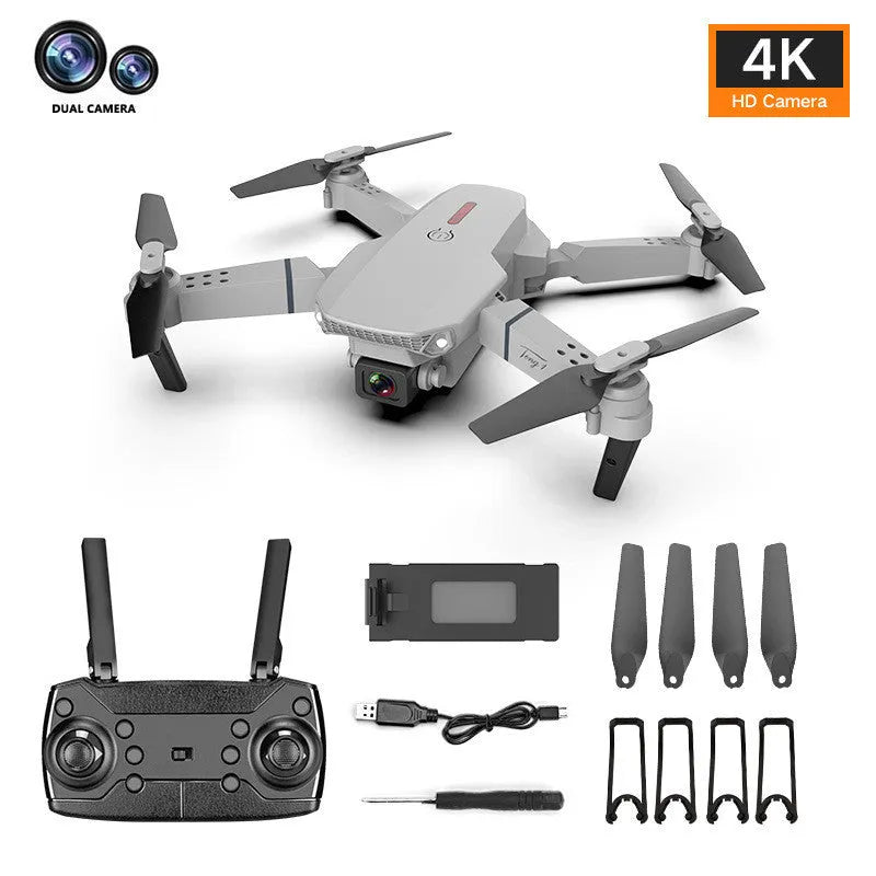 Grey foldable 4K dual camera drone with remote controller on a table.