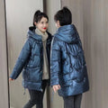 A woman's loose-fit hooded winter jacket in a thick fabric, shown in a choice of colours.