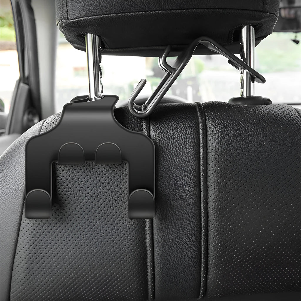 Two white ABS plastic car hooks for mounting phones and organising items in vehicles.
