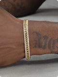 Gold tennis bracelet with artificial gemstone inlay on titanium steel band