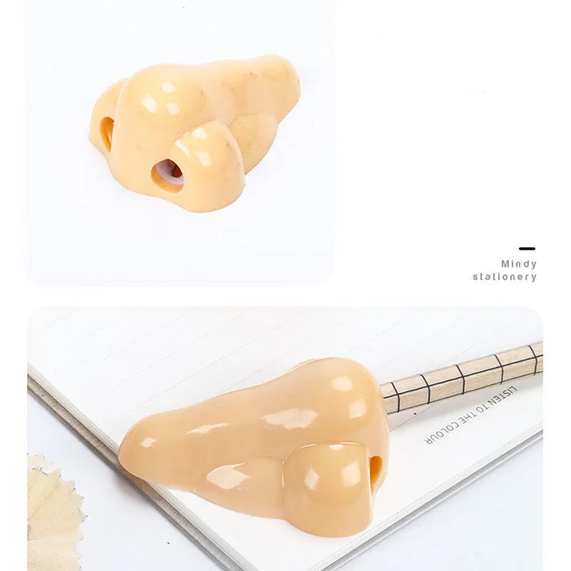 Flesh colour plastic manual pencil sharpener with big nostril hole on geometric body.