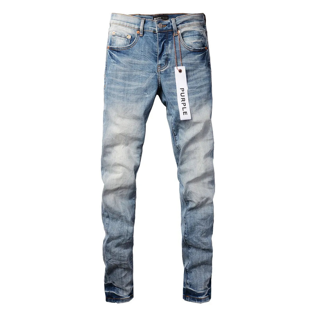 Men's blue denim pencil leg jeans with low waist and zipper fly on a person standing