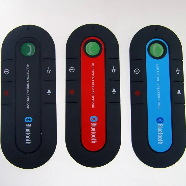 Black car Bluetooth handsfree kit clipped to a sun visor, showing the speaker grille and included car charger.