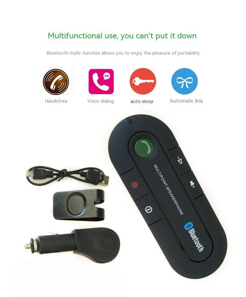 Black car Bluetooth handsfree kit clipped to a sun visor, showing the speaker grille and included car charger.