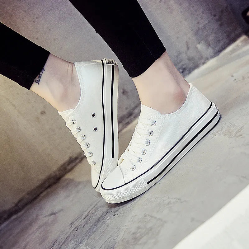 Women's canvas casual shoes in solid colours showing black, white black, white red, and all black options