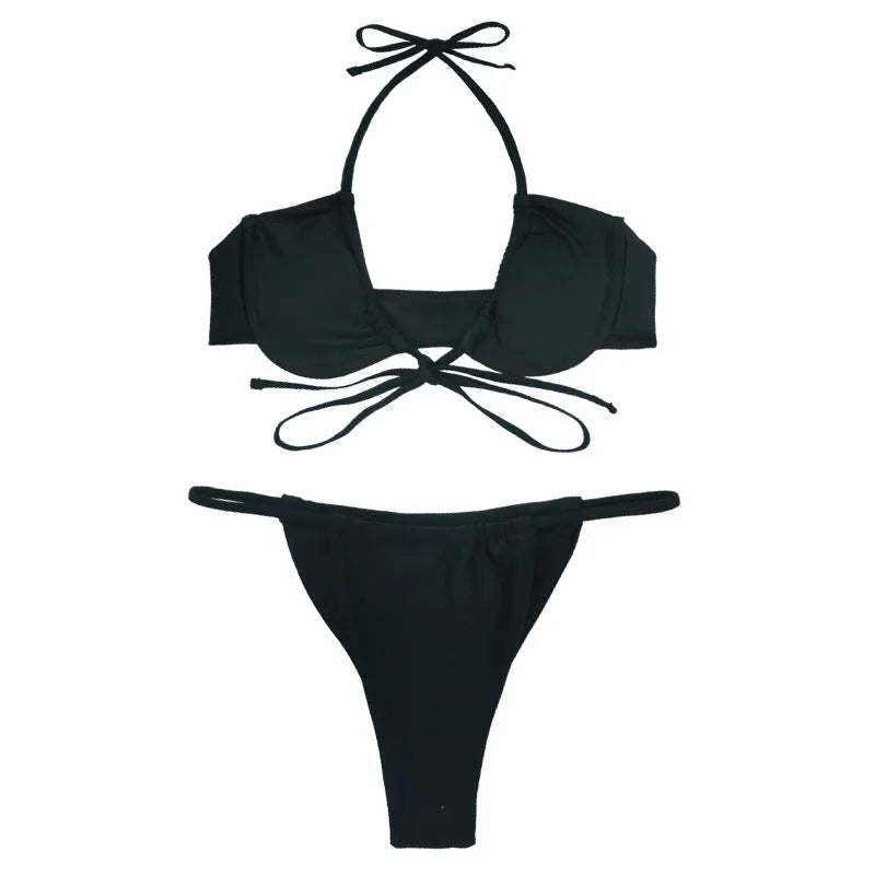 Women's black and mint green two-piece nylon bikini swimsuit laid flat.
