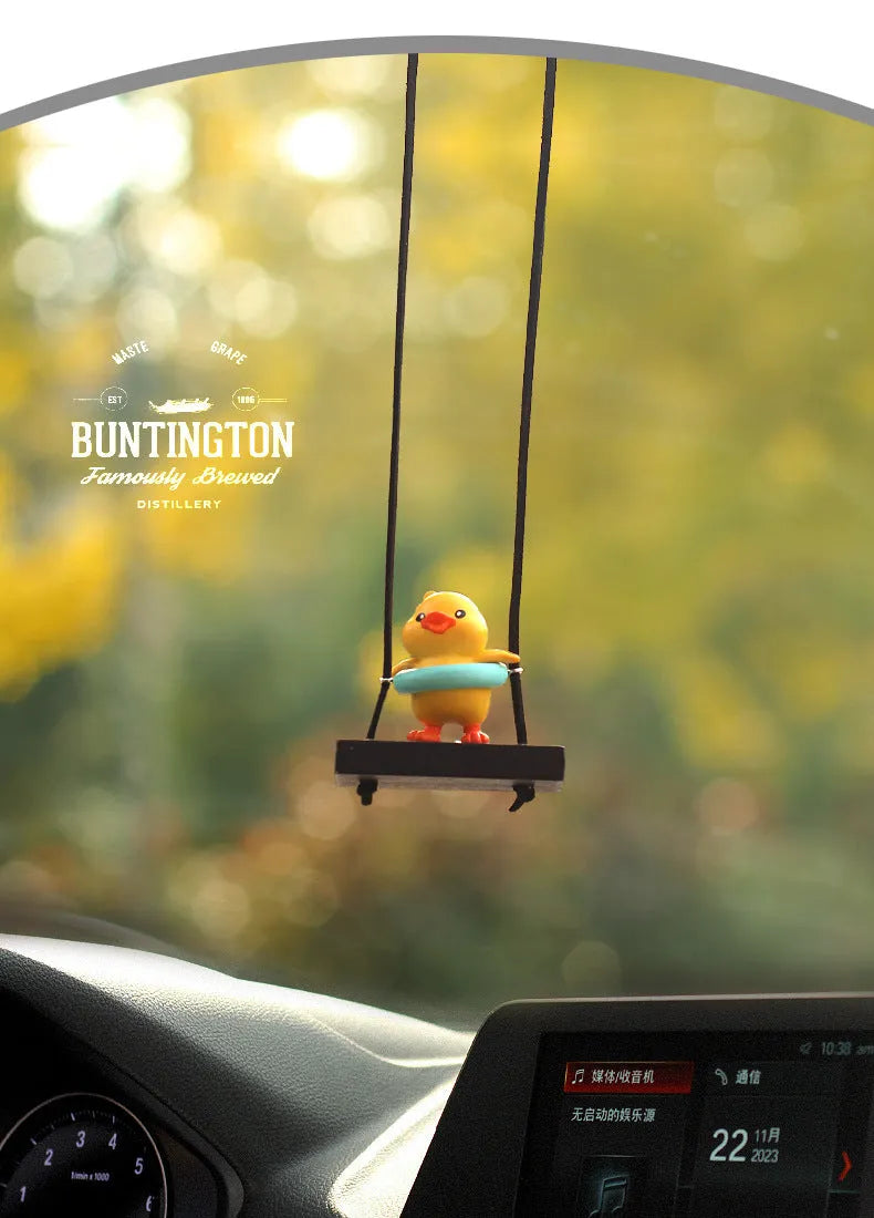 Cute little yellow plastic duck doll car hanging ornament in cartoon style.