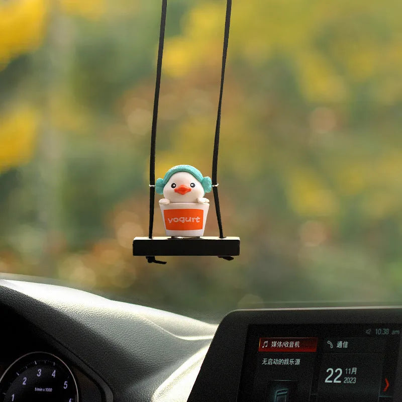 Cute little yellow plastic duck doll car hanging ornament in cartoon style.