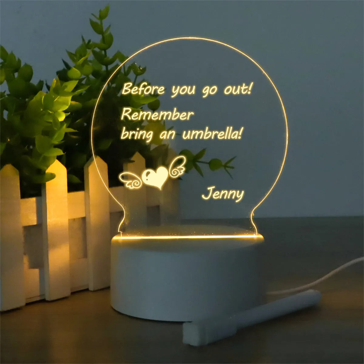 Heart-shaped LED light note board with USB warm yellow glow, base, and pen on a desk